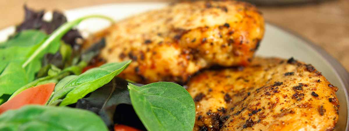 Roasted herb chicken breast served with rice pilaf and green beans
